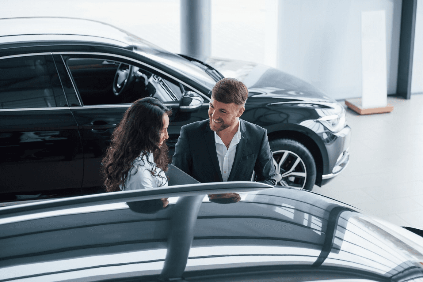Two cars on display at a dealership